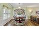 Elegant dining area showcases a round wood table, with decor, set on a stylish rug, illuminated by a pendant light at 1439 Brighton Ave., Myrtle Beach, SC 29588