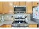 Close up of kitchen featuring stainless steel stove and microwave, and ample countertop space at 1439 Brighton Ave., Myrtle Beach, SC 29588
