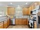 Modern kitchen boasts stainless steel appliances, ample counter space, and natural wood cabinets at 1439 Brighton Ave., Myrtle Beach, SC 29588