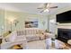 Bright living room features a comfy sectional, modern decor, and a ceiling fan at 1439 Brighton Ave., Myrtle Beach, SC 29588