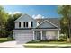 Charming two-story home with light blue siding, black shutters, and a well-manicured front lawn at 1517 Seachase Way, North Myrtle Beach, SC 29582