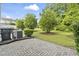 Backyard with lush landscaping, mature trees, and a brick patio at 157 Olde Towne Way # 4, Myrtle Beach, SC 29588