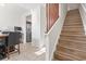 Entryway with staircase featuring hardwood steps, adjacent dining area and stainless steel refrigerator at 157 Olde Towne Way # 4, Myrtle Beach, SC 29588