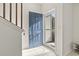 Bright foyer featuring tiled flooring, a stylish blue front door, and a staircase at 157 Olde Towne Way # 4, Myrtle Beach, SC 29588