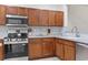 Kitchen with stylish wood cabinets, modern appliances, and tile backsplash at 157 Olde Towne Way # 4, Myrtle Beach, SC 29588