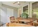 Covered patio featuring wood table, ceiling fan and windows with great natural light at 157 Olde Towne Way # 4, Myrtle Beach, SC 29588