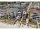 Stunning aerial view of beach homes featuring pools and private beach access at 1611A S Ocean Blvd., Surfside Beach, SC 29575