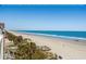 Beach view of the sandy beach and ocean view with multiple access points from nearby homes at 1611A S Ocean Blvd., Surfside Beach, SC 29575