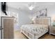 Comfortable bedroom features a beach-themed comforter, ceiling fan, and natural light from the window at 1611A S Ocean Blvd., Surfside Beach, SC 29575