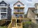 New beach home is shown under construction with decks and stairs leading to the ground at 1611A S Ocean Blvd., Surfside Beach, SC 29575