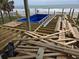 Beach home under construction with deck framing and a blue pool being installed at 1611A S Ocean Blvd., Surfside Beach, SC 29575