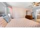 Bright bedroom with ceiling fan, wood dresser, and neutral carpet at 189 Sea Turtle Dr., Myrtle Beach, SC 29588