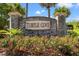 Beautiful brick Turtle Cove community sign with blooming roses and palm trees at 189 Sea Turtle Dr., Myrtle Beach, SC 29588