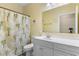 Bathroom with a white vanity, toilet, and a shower-tub combo with a palm tree curtain at 200 53Rd Ave. N # 409, North Myrtle Beach, SC 29582