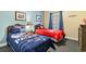 Bedroom with two twin beds, sports-themed decor, and a window for natural light at 200 53Rd Ave. N # 409, North Myrtle Beach, SC 29582