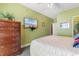Bright bedroom featuring a queen bed, TV, dresser, and ensuite bath access at 200 53Rd Ave. N # 409, North Myrtle Beach, SC 29582
