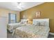 Bedroom with two beds, floral bedding, a ceiling fan, and a window at 200 53Rd Ave. N # 409, North Myrtle Beach, SC 29582