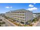 Beautiful exterior view of the multilevel condo complex with private balconies and ample parking at 200 53Rd Ave. N # 409, North Myrtle Beach, SC 29582