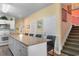 Open kitchen featuring granite counters and bar seating adjacent to the staircase at 200 53Rd Ave. N # 409, North Myrtle Beach, SC 29582