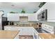 Well-equipped kitchen with white cabinets, granite counters, and modern appliances at 200 53Rd Ave. N # 409, North Myrtle Beach, SC 29582