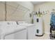 Laundry room featuring a washer, dryer, water heater, and storage shelf at 200 53Rd Ave. N # 409, North Myrtle Beach, SC 29582
