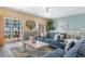 Open-concept living room with balcony access and plush seating perfect for entertaining and relaxation at 200 53Rd Ave. N # 409, North Myrtle Beach, SC 29582