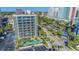 Aerial view of condo building featuring palm trees around pool and parking lot, and balconies on each floor at 200 76Th Ave. N # 408, Myrtle Beach, SC 29572