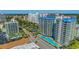 Aerial view showcasing the complex's pools and beautiful cityscape location with multiple buildings, and palm trees at 200 76Th Ave. N # 408, Myrtle Beach, SC 29572