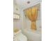 Bathroom showcasing shower with gold curtain, a gold shelf with toilet paper and butterfly decals on the white wall at 200 76Th Ave. N # 408, Myrtle Beach, SC 29572