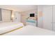 Comfortable bedroom with two beds, TV, dresser, and calming decor for a relaxing stay at 200 76Th Ave. N # 408, Myrtle Beach, SC 29572