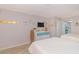 Spacious bedroom with two beds, a dresser, and a view of the kitchen providing essential comforts and conveniences at 200 76Th Ave. N # 408, Myrtle Beach, SC 29572
