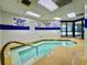 Indoor hot tub featuring tiled walls, adequate lighting, and safety signage for a relaxing experience at 200 76Th Ave. N # 408, Myrtle Beach, SC 29572