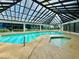 Inviting indoor swimming pool with a clear skylight, alongside a hot tub for relaxation and enjoyment at 200 76Th Ave. N # 408, Myrtle Beach, SC 29572