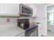 Compact kitchen with a stainless steel microwave and electric range offering essential amenities at 200 76Th Ave. N # 408, Myrtle Beach, SC 29572