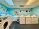 Bright laundry room equipped with multiple washing machines and dryers for convenient resident use at 200 76Th Ave. N # 408, Myrtle Beach, SC 29572