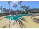 Outdoor pool area featuring inviting turquoise waters, surrounded by lush palm trees and well-kept landscaping at 200 76Th Ave. N # 408, Myrtle Beach, SC 29572