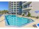 Outdoor pool surrounded by lounge chairs and condos, offering a perfect spot to soak up the sun and relax at 200 76Th Ave. N # 408, Myrtle Beach, SC 29572