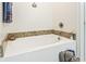 Soaking tub with granite surround and stylish fixtures at 210 Fox Hunt Pl., Aynor, SC 29511