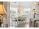 Airy dining room featuring a chandelier, white chairs, and natural light at 210 Fox Hunt Pl., Aynor, SC 29511