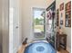Inviting entryway featuring wood floors, a blue rug, and a stylish black door with an oval window at 210 Fox Hunt Pl., Aynor, SC 29511