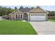 Charming single-Gathering home featuring a two-car garage and a beautifully maintained green lawn at 210 Fox Hunt Pl., Aynor, SC 29511