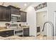 Modern kitchen with stainless steel appliances, dark cabinetry, and granite countertops at 210 Fox Hunt Pl., Aynor, SC 29511
