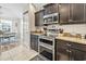 Modern kitchen features stainless steel appliances, granite countertops, and dark wood cabinets at 210 Fox Hunt Pl., Aynor, SC 29511