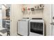 Convenient laundry room with modern washer and dryer, complemented with storage shelving at 210 Fox Hunt Pl., Aynor, SC 29511