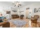 Open living area with hardwood floors, kitchen access, and plenty of seating at 210 Fox Hunt Pl., Aynor, SC 29511