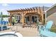 Outdoor patio area with a pergola, seating, and a jacuzzi at 210 Fox Hunt Pl., Aynor, SC 29511