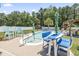 Inviting backyard pool area with ample seating, umbrellas, and a well-maintained garden at 210 Fox Hunt Pl., Aynor, SC 29511