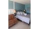 Cozy bedroom featuring an accent wall, a comfortable bed, and a plush brown chair at 2207 S Ocean Blvd. # 1407, Myrtle Beach, SC 29577