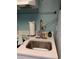 Close-up of a kitchenette area with a stainless steel sink, countertop, and mounted paper towels at 2207 S Ocean Blvd. # 1407, Myrtle Beach, SC 29577
