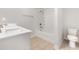 Clean bathroom featuring white fixtures, a shower-tub combo, and neutral tile flooring for a modern look at 2409 Thoroughfare Dr. # 2409, North Myrtle Beach, SC 29582